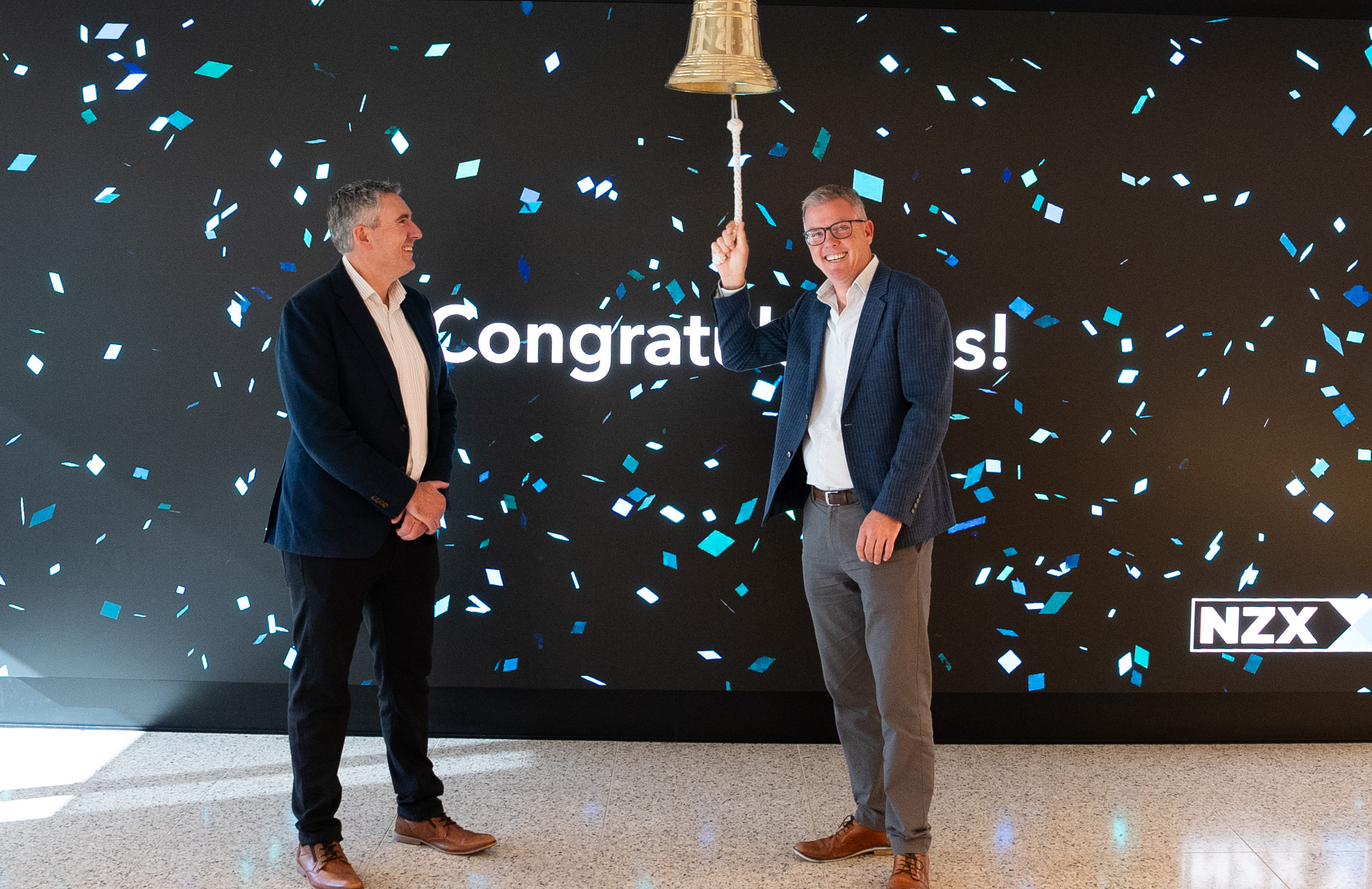 Image of Vital CEO ringing NZX bell to celebrate 20 years on the NZX